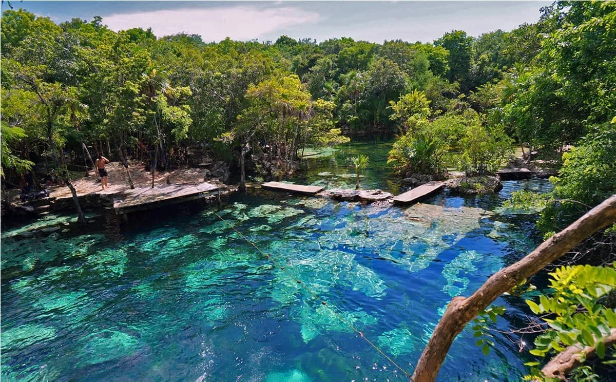 Turquoise water and jungle ledges at Cenote Azul south of Playa del Carmen