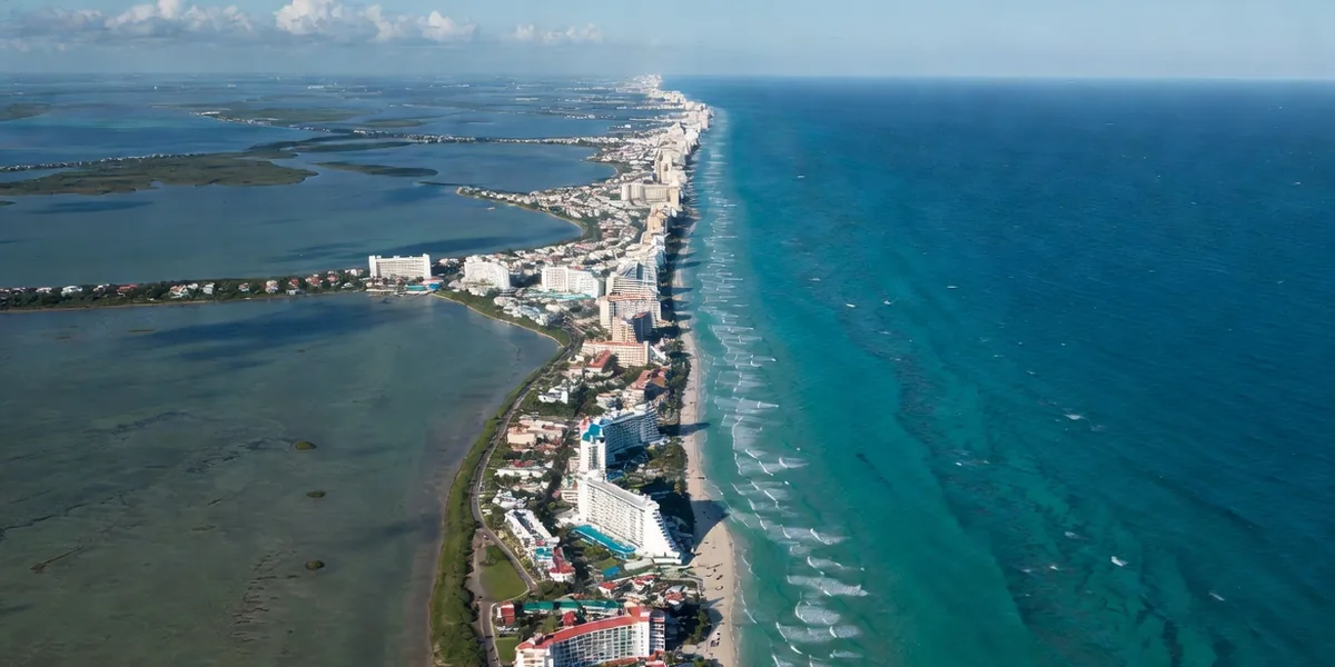 Aerial view of Cancún's Hotel Zone strip between the Nichupté Lagoon and the turquoise Caribbean