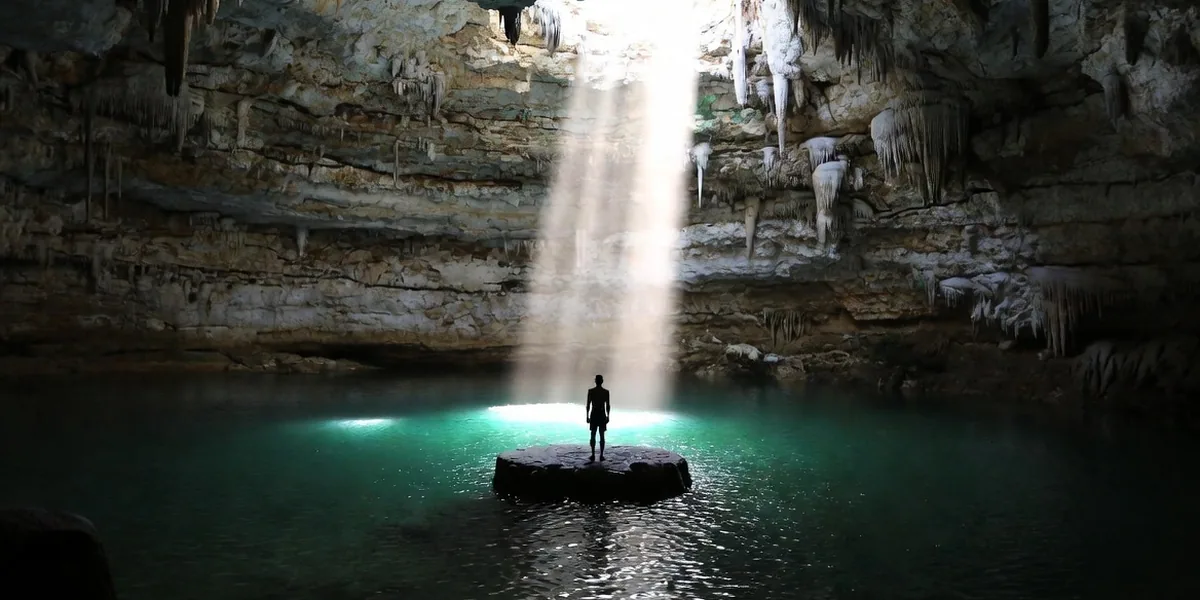 Light beam hitting the round stone platform inside Cenote Suytun near Valladolid