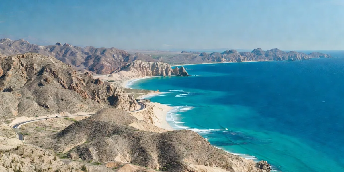 Desert cliffs and turquoise coves along the Los Cabos Tourist Corridor between Cabo San Lucas and San José
