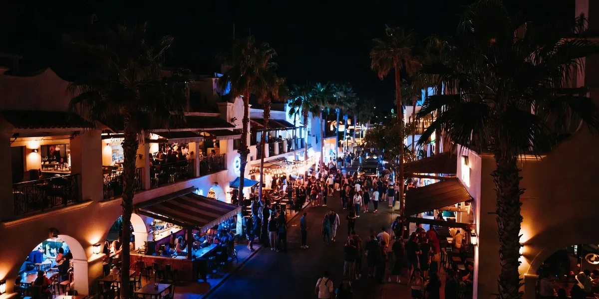 Open-front bars and crowds under neon on the Cabo San Lucas nightlife strip