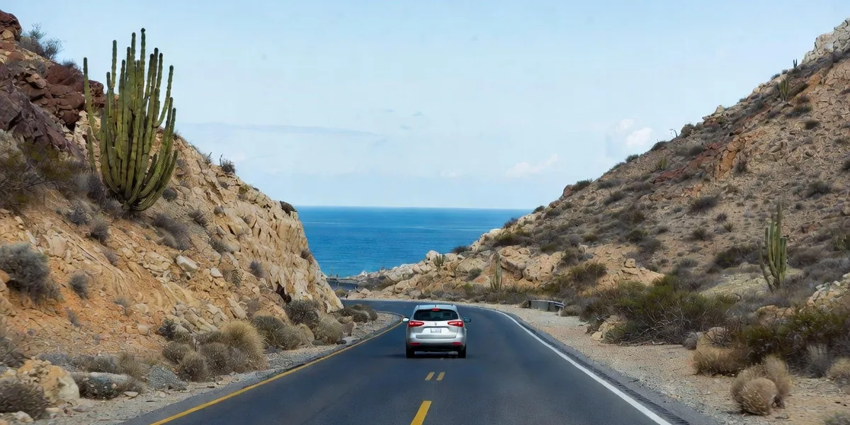 Rental car on the Transpeninsular highway where the Baja desert meets the sea, Los Cabos