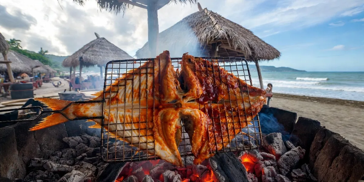 Pescado zarandeado grilling butterflied over wood coals at a Nayarit beach restaurant